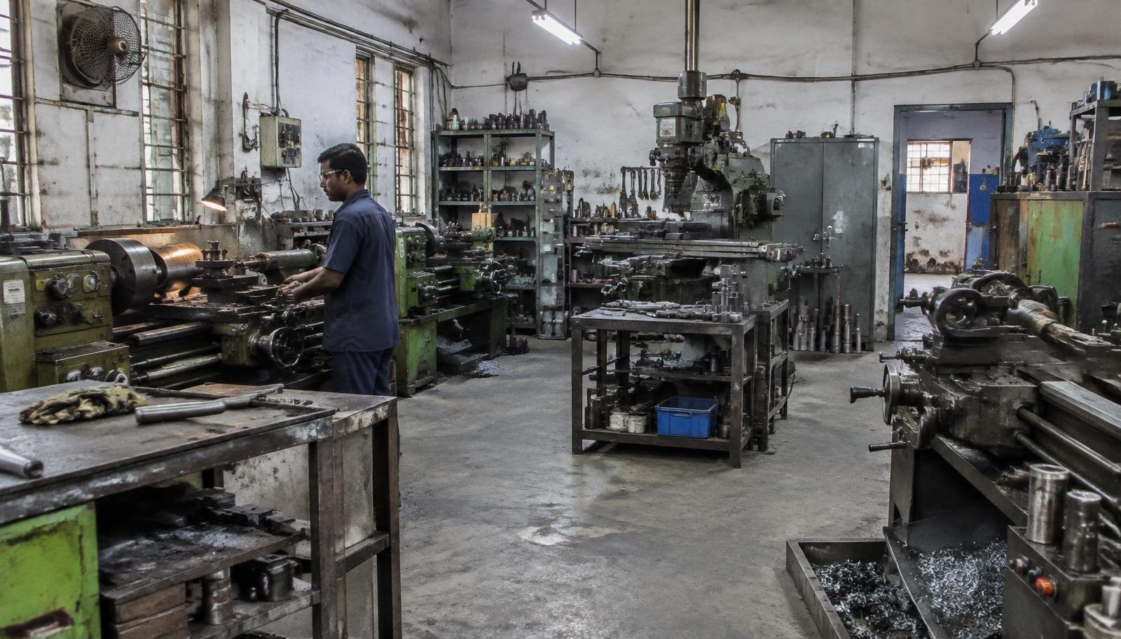Machinist working on a lathe in a precision machine shop in Hyderabad
